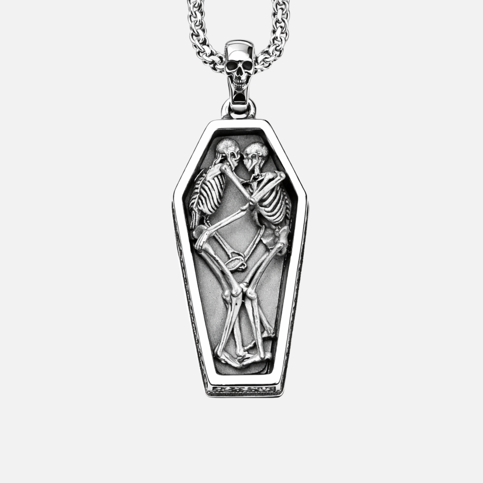 Eternal Vow gothic coffin pendant with two embracing skeletons inside, skull bail, and polished stainless steel finish on wheat chain