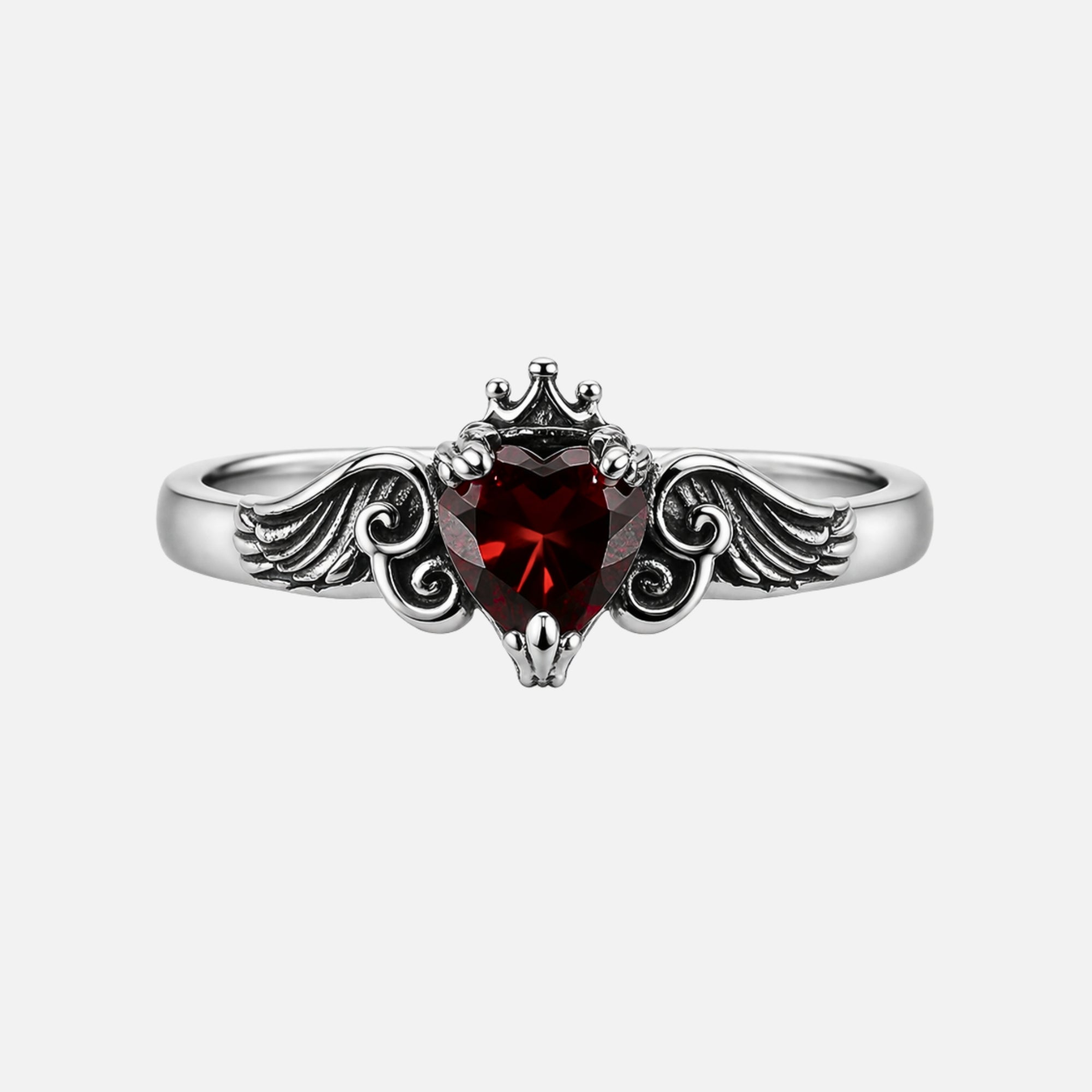 Crimson Wing gothic ring with red zirconia heart stone, feathered wing design along band, and crown prong setting in polished stainless steel