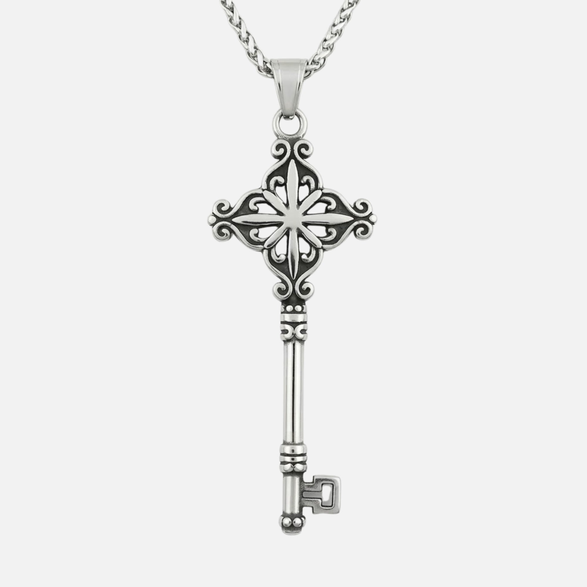 Skeleton Key gothic pendant necklace with ornate filigree bow, star motif center, and classic key design in polished stainless steel