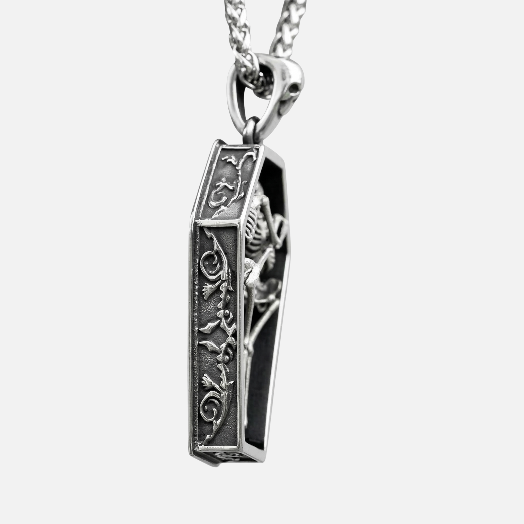 Side view of Eternal Vow coffin pendant showing detailed vine engravings on stainless steel frame